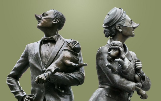 The two snooty statues side by side: the man with a pug and the woman with a poodle